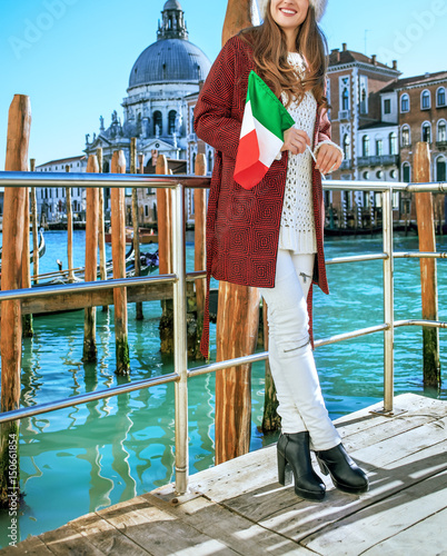 woman on embankment with Italian flag looking into distance