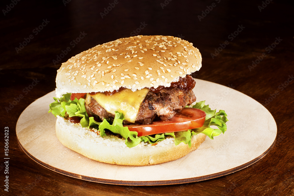Hamburger with barbecue sauce on a cutting board Hamburger with barbecue sauce on a cutting board