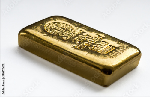 Cast gold bar weighing 250 grams. On a light background. Selective focus..