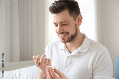 Young man with contact lens...