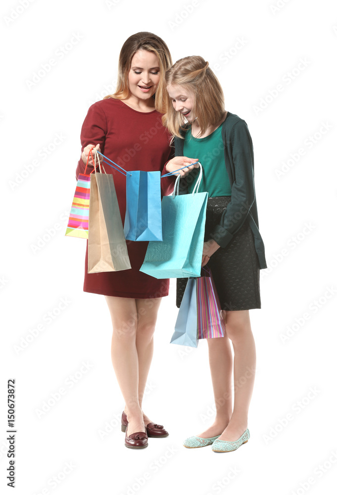 Mother and daughter with paper bags on white background Mother and daughter with paper bags on white background