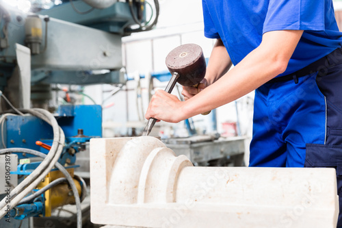 Female Stonemason carving pillar