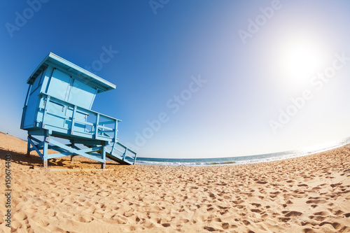 Deserted sea shore with wooden lifeguard tower