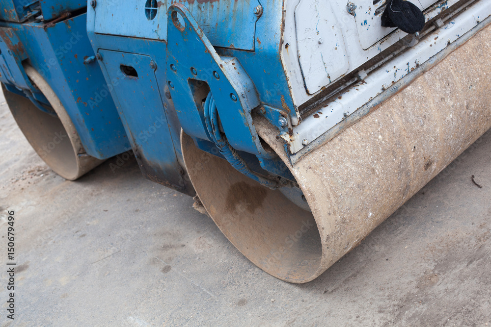 Fototapeta premium Blue construction road roller. A large and powerful blue road roller on the construction site.