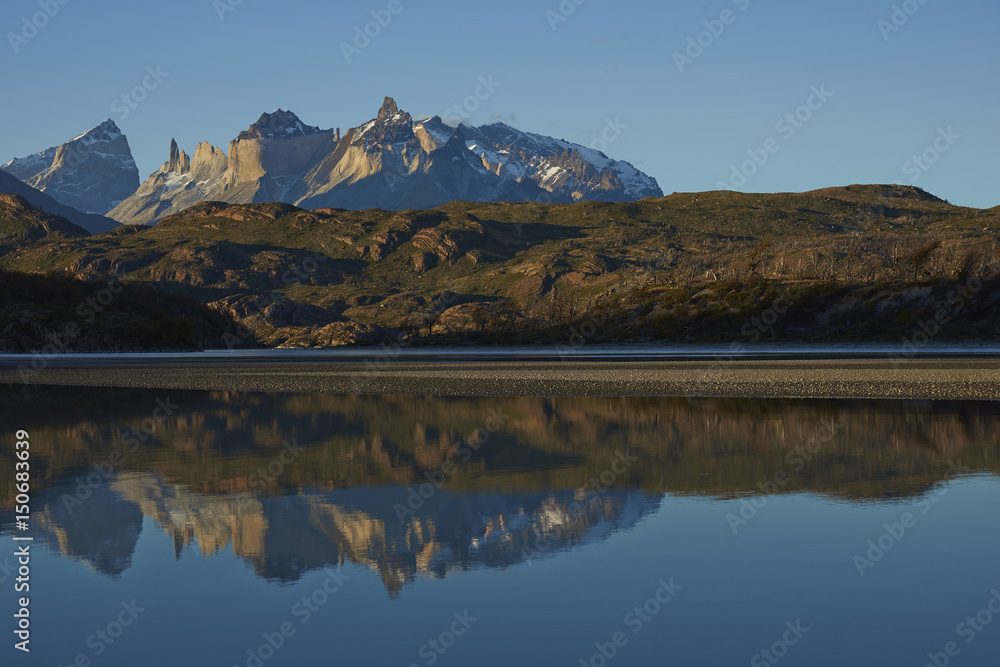 Mountain peaks of Cuernos del Paine rising above the southern end of Lago Grey in Torres del Paine National Park in Patagonia, Chile.