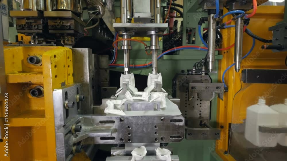 Automatic machine for producing PET bottles at a modern factory. 4K. Automatic machine for producing PET bottles at a modern factory. 4K.