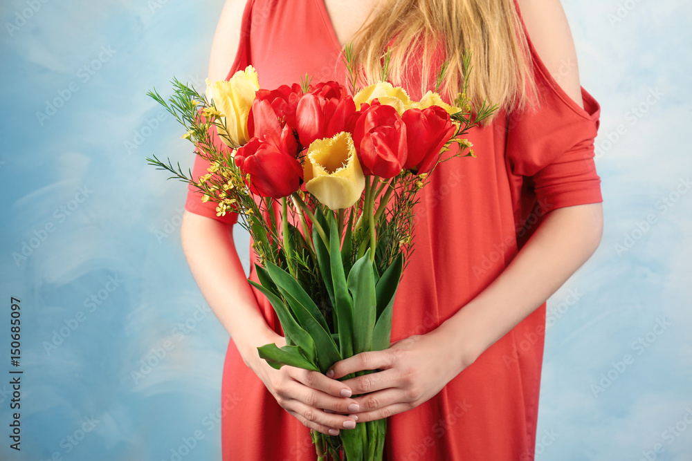 Beautiful young woman with bouquet of flowers on color background, closeup