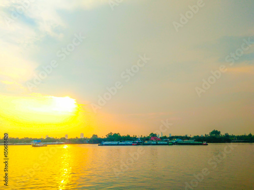 A tugboat tug on the Chao Phraya river sunset