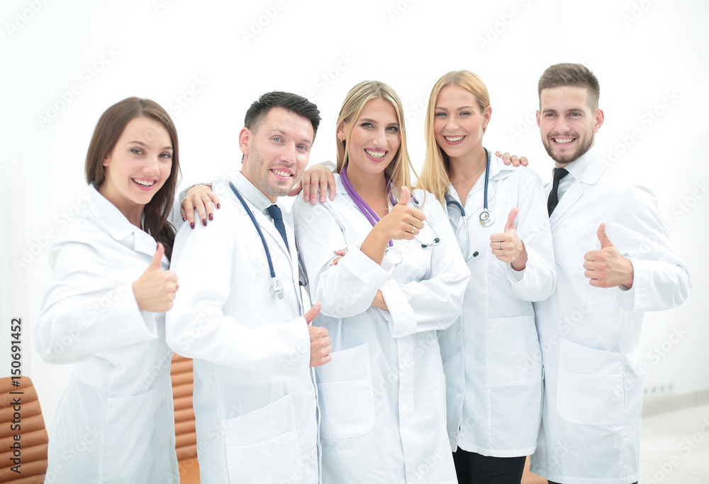 Happy and confident team of doctors posing on camera Happy and confident team of doctors posing on camera