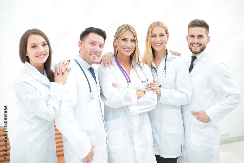 Happy and confident team of doctors posing on camera Happy and confident team of doctors posing on camera