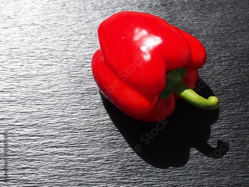 Sprong red bell pepper on black surface