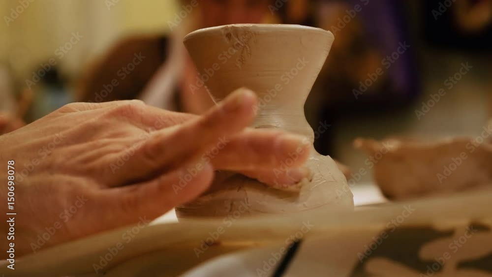 Child ceramist sculptor is modeling clay pot or ceramics vase bowl. Art and handicraft modelling creation. Child ceramist sculptor is modeling clay pot or ceramics vase bowl. Art and handicraft modelling creation.