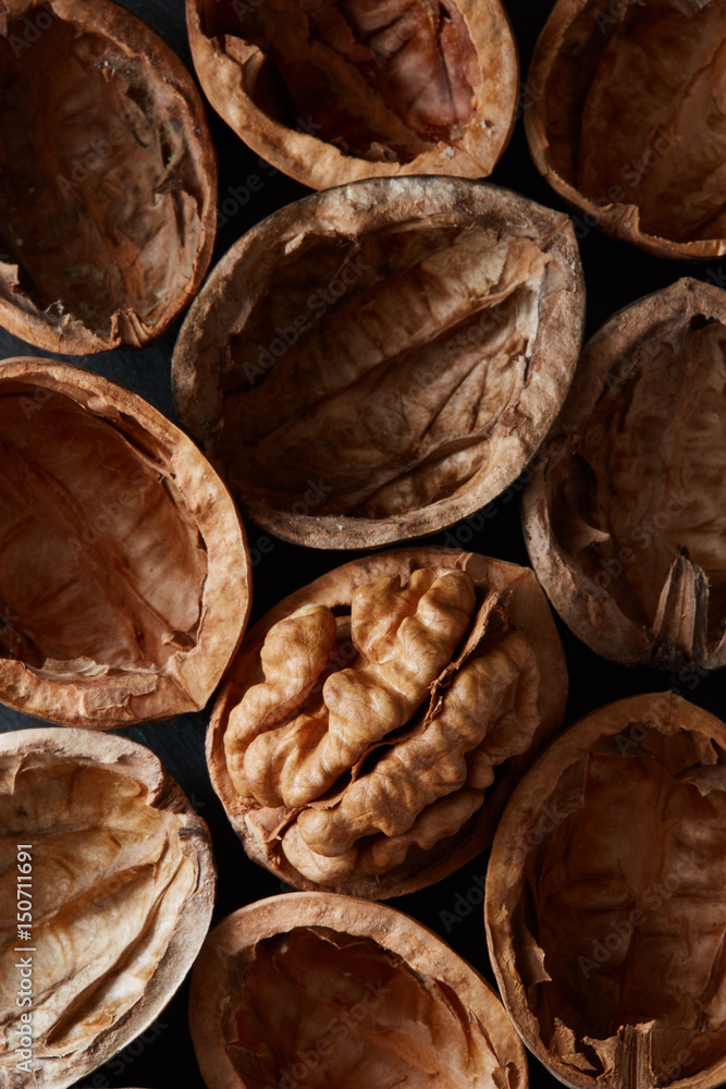 Macro close-up crop of walnuts shells as food backdrop composition