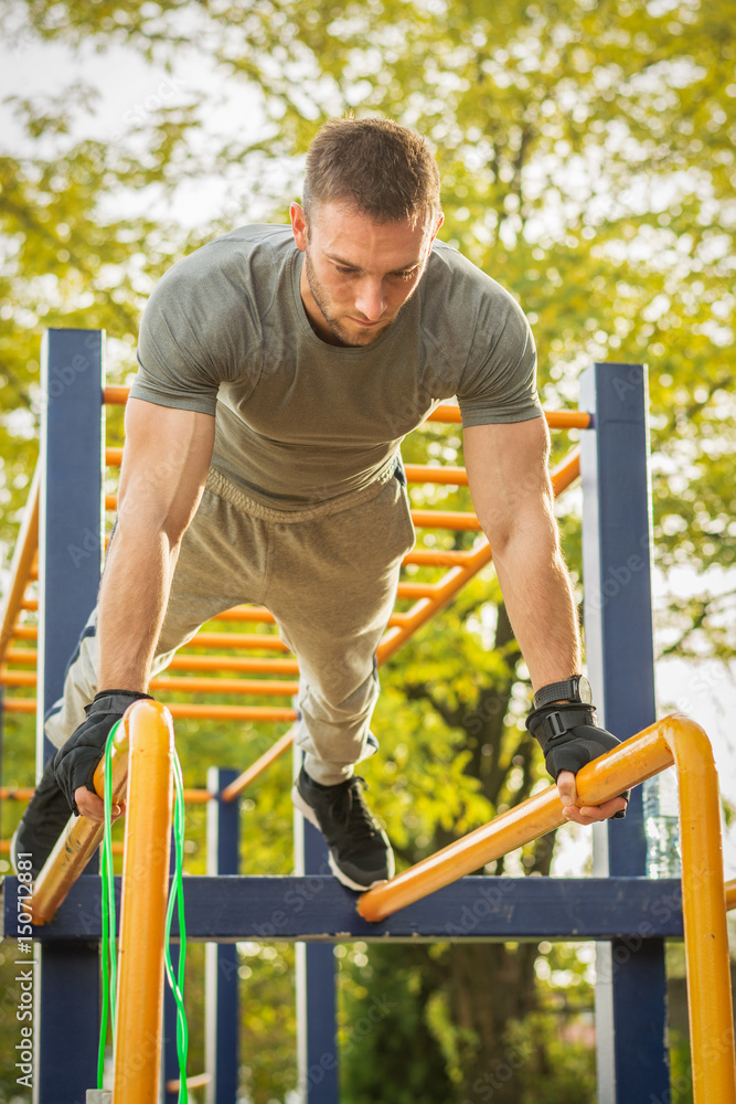 Push-ups - fitness man training push up outside in summer. Push-ups - fitness man training push up outside in summer.