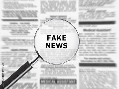 Canvas Print Newspaper under magnifying glass exposing fake news