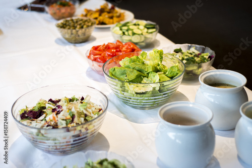 Variety of fresh salads bowls on buffet table business dinner