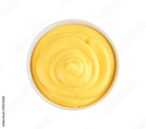 Bowl with cheese sauce on white background photo