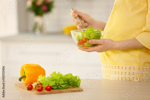 Young pregnant woman eating...