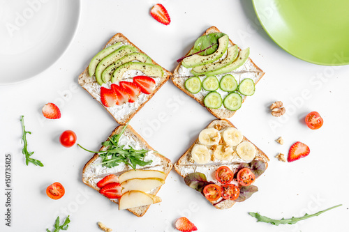 healthy breakfast with sandwiches set on white background top view