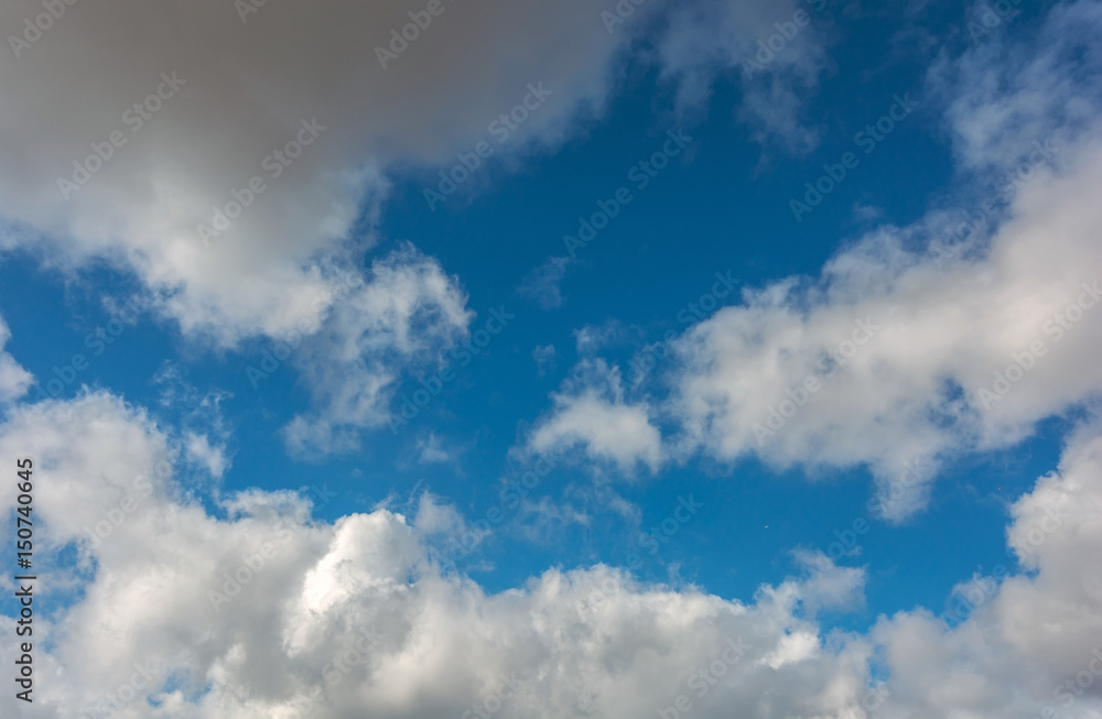 Voluminous clouds on a blue summer . Voluminous clouds on a blue summer .