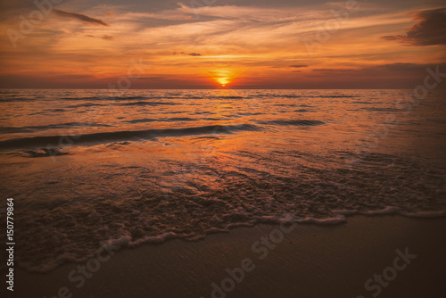 Fototapeta Naklejka Na Ścianę i Meble -  Golden sunrise sunset over the sea ocean waves