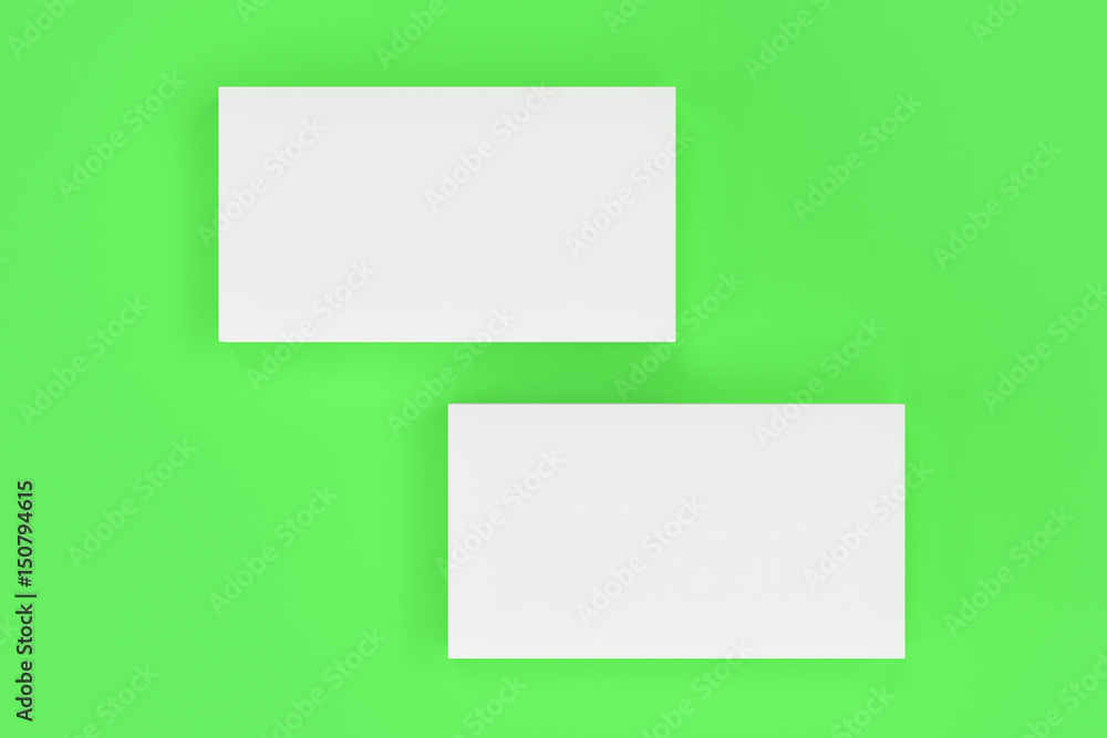 White blank business cards mock-up on green background White blank business cards mock-up on green background