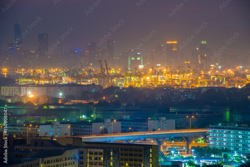 Container port with cityscape at night  in Bangkok, Thailand.