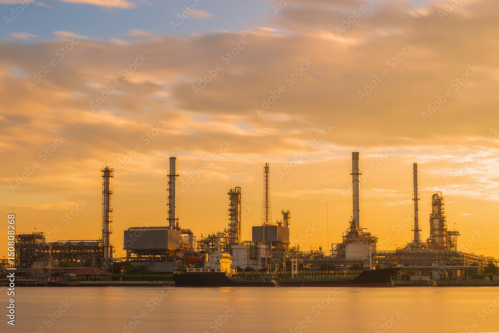 Oil refinery or petroleum refinery industrial process plant with sunrise, oil refineries use much of the technology, as types of chemical plants, the downstream side of the petroleum industry.