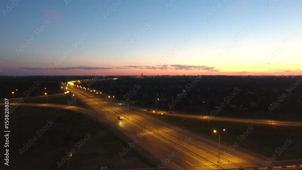 Aerial view. Traffic at illuminated highway interchange. Evening traffic. Aerial view. Traffic at illuminated highway interchange. Evening traffic.
