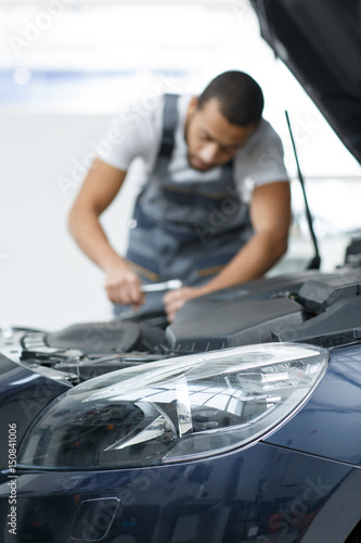 Professional car mechanic repairing a car