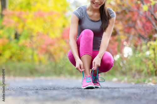 Quadro su tela Running shoes woman runner tying shoe lace for run