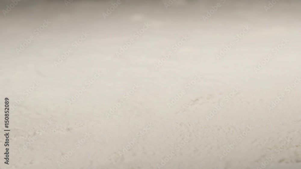 SLOW MOTION: Falling a chicken leg to a flour - macro shot SLOW MOTION: Falling a chicken leg to a flour - macro shot