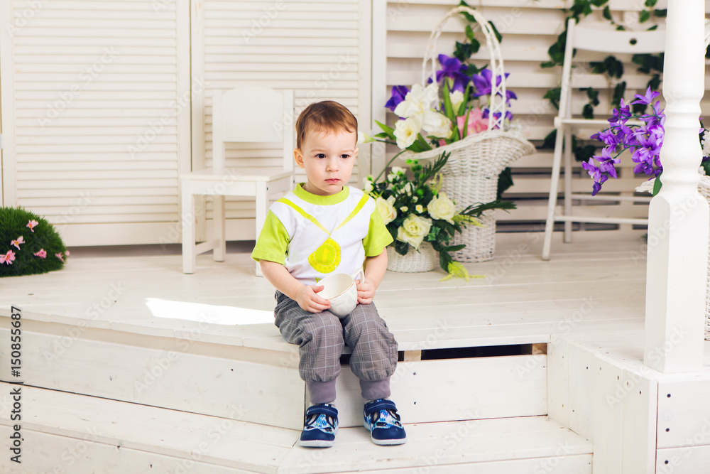 Sad boy with cup in room Sad boy with cup in room