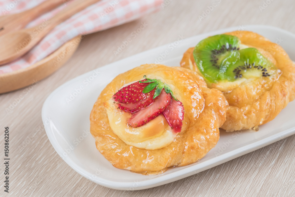 Danish pastry with fruit on plate. Danish pastry with fruit on plate.