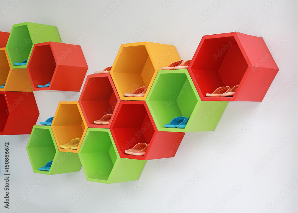 Colorful Modern Shoe Rack on the white wall.
Colorful Modern Shoe Rack on the white wall.