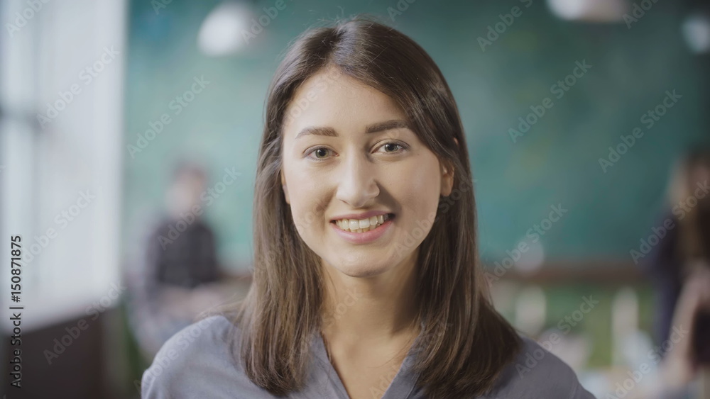 Portrait of attractive Asian businesswoman at loft office. Successful female worker turns, looks around and smiling. Portrait of attractive Asian businesswoman at loft office. Successful female worker turns, looks around and smiling.