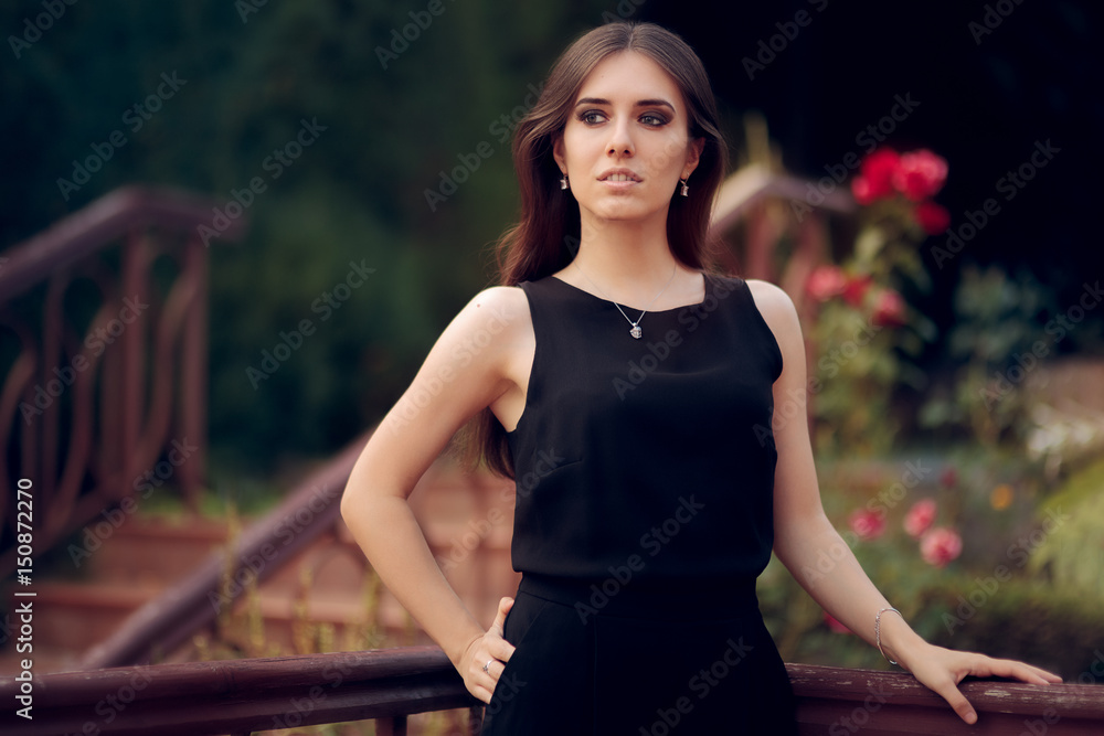 Elegant Woman Wearing Black Dress Standing in a Patio