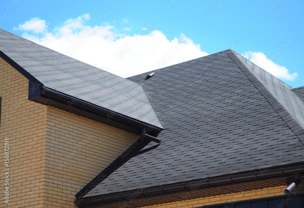 Fototapeta premium Asphalt shingles roofing construction, repair. Problem Areas for House asphalt shingles Corner Roofing Construction Waterproofing. Rain gutter system.