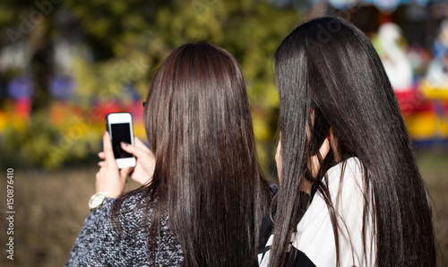 Girl with long hair with a cell phone