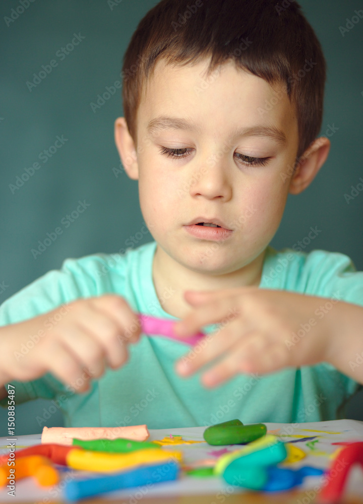 Boy playing with color play dough Boy playing with color play dough
