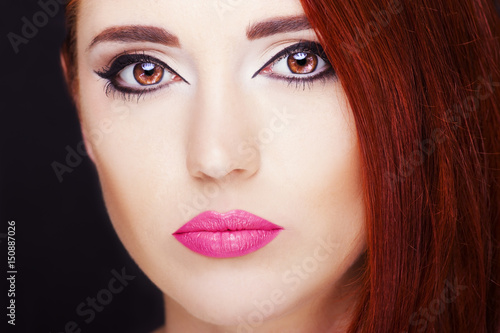 Portrait of a beautiful redhead woman. Perfect makeup.