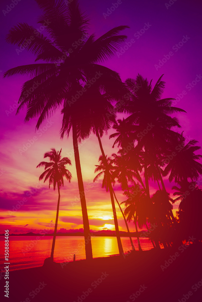Fototapeta premium Silhouette coconut palm trees on beach at sunset. Vintage tone.