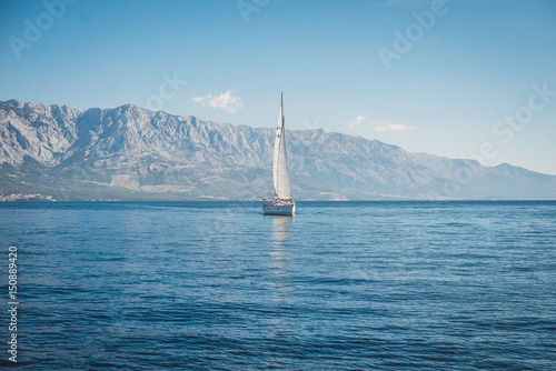 Sailing yacht in the sea against the backdrop of mountains