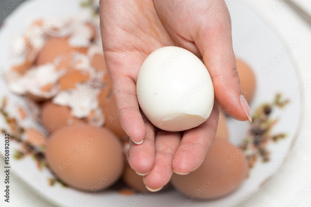 The girl is cleaning the egg with her hands The girl is cleaning the egg with her hands