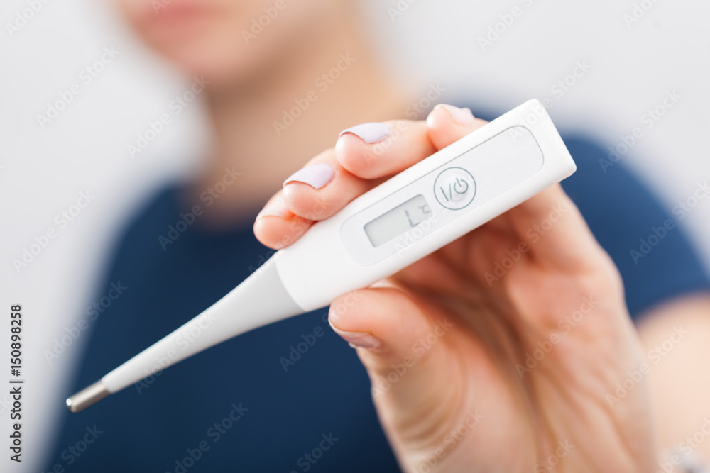 Sick women with a thermometer Sick women with a thermometer