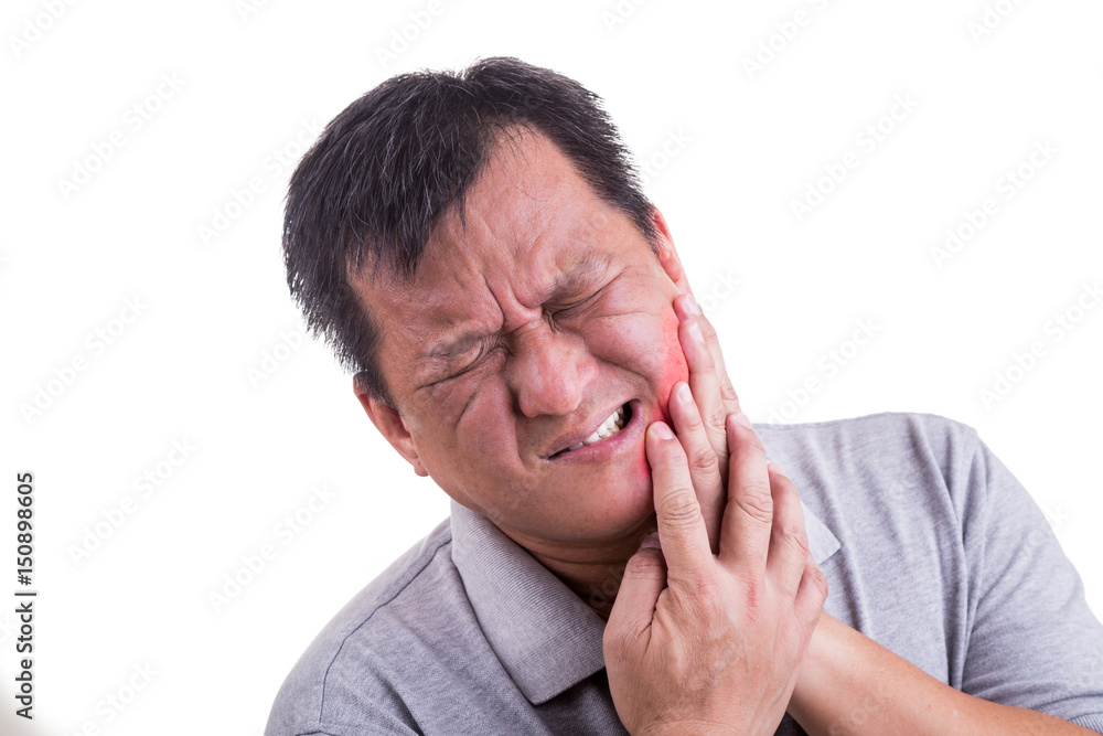 Matured man suffering intense toothache pain with hands over face Matured man suffering intense toothache pain with hands over face