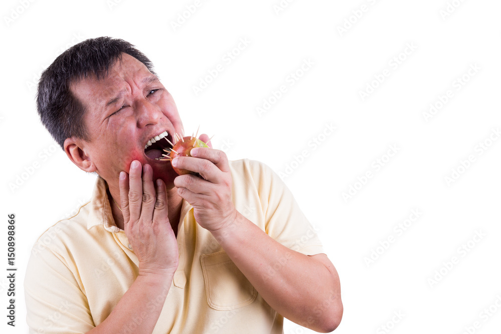 Conceptual man with toothache pain after biting apple with thorns Conceptual man with toothache pain after biting apple with thorns