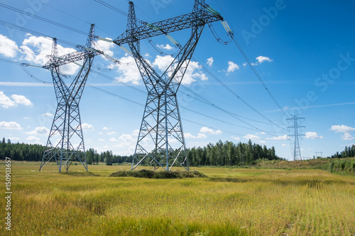 Landscape with electric lines at bright summer day in Finland