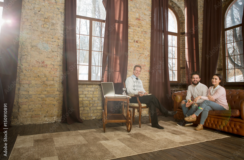 Couple staying at psychologist's office and sharing their family problems. Visiting psychology is way to happy family life. Psychology concept.