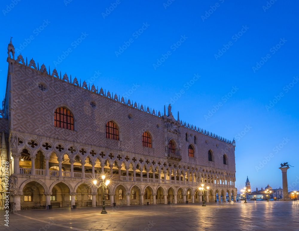 Dodges Palace in Venice at Dawn with blue sky and lights on.